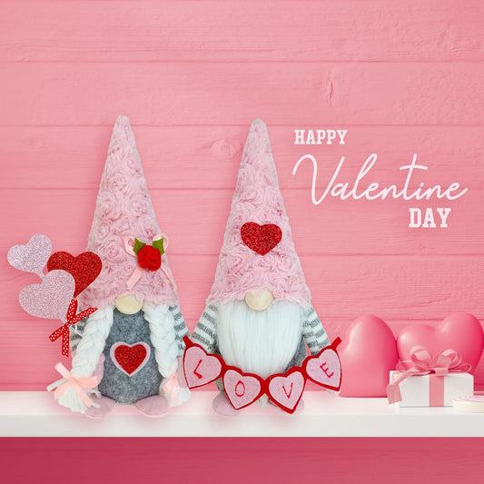 Handcrafted Mr. and Mrs. Valentine's Day gnomes with pink Sunday Angora furry hats, a 'LOVE' banner, and heart-shaped balloons on a white mantle with a pink wood background.