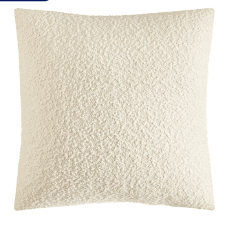 Textured beige pillow on a white background