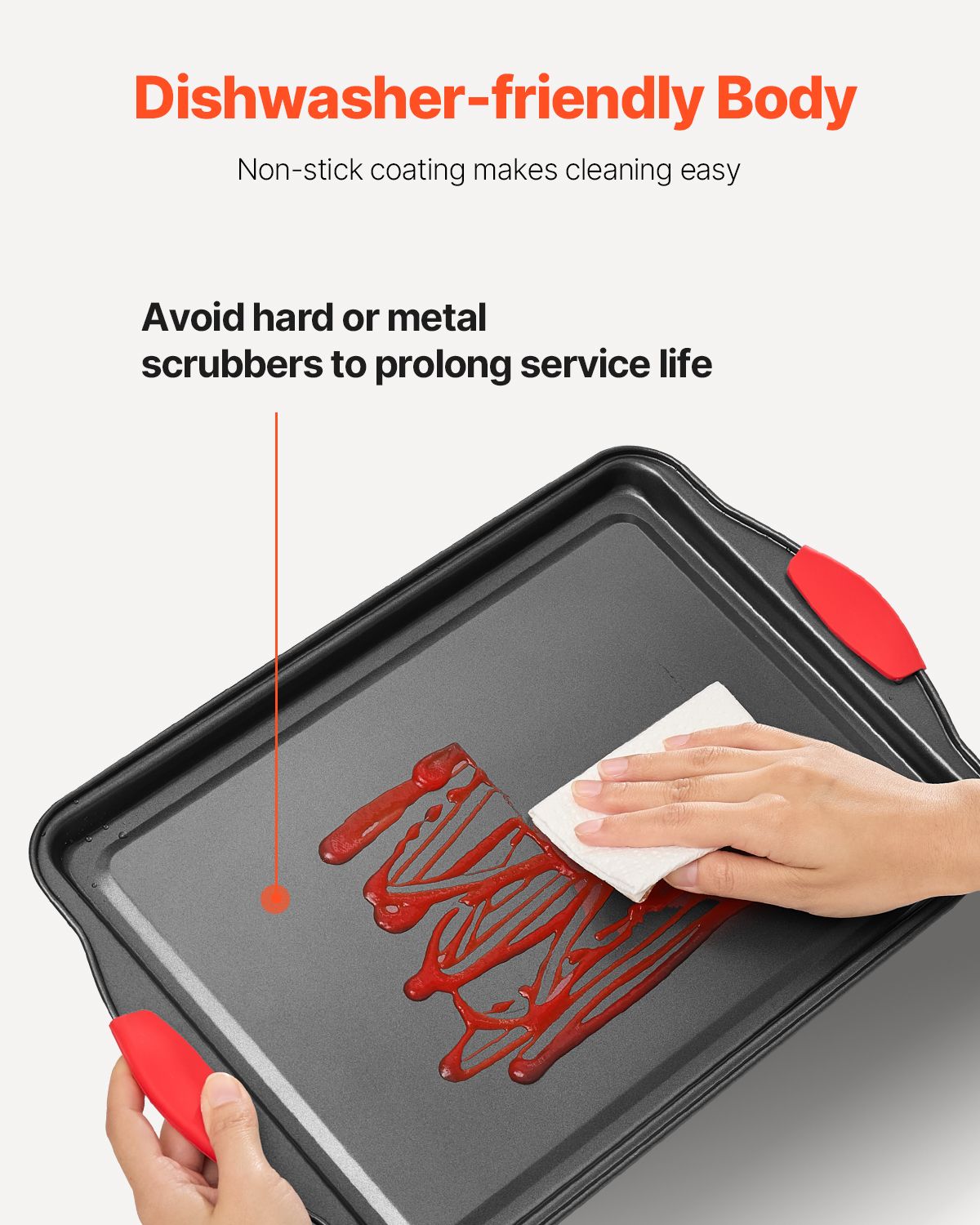 Dishwasher-friendly baking tray with red handles being cleaned on a white background