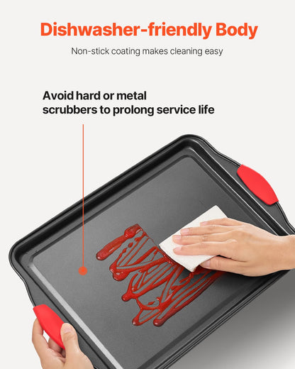 Dishwasher-friendly baking tray with red handles being cleaned on a white background