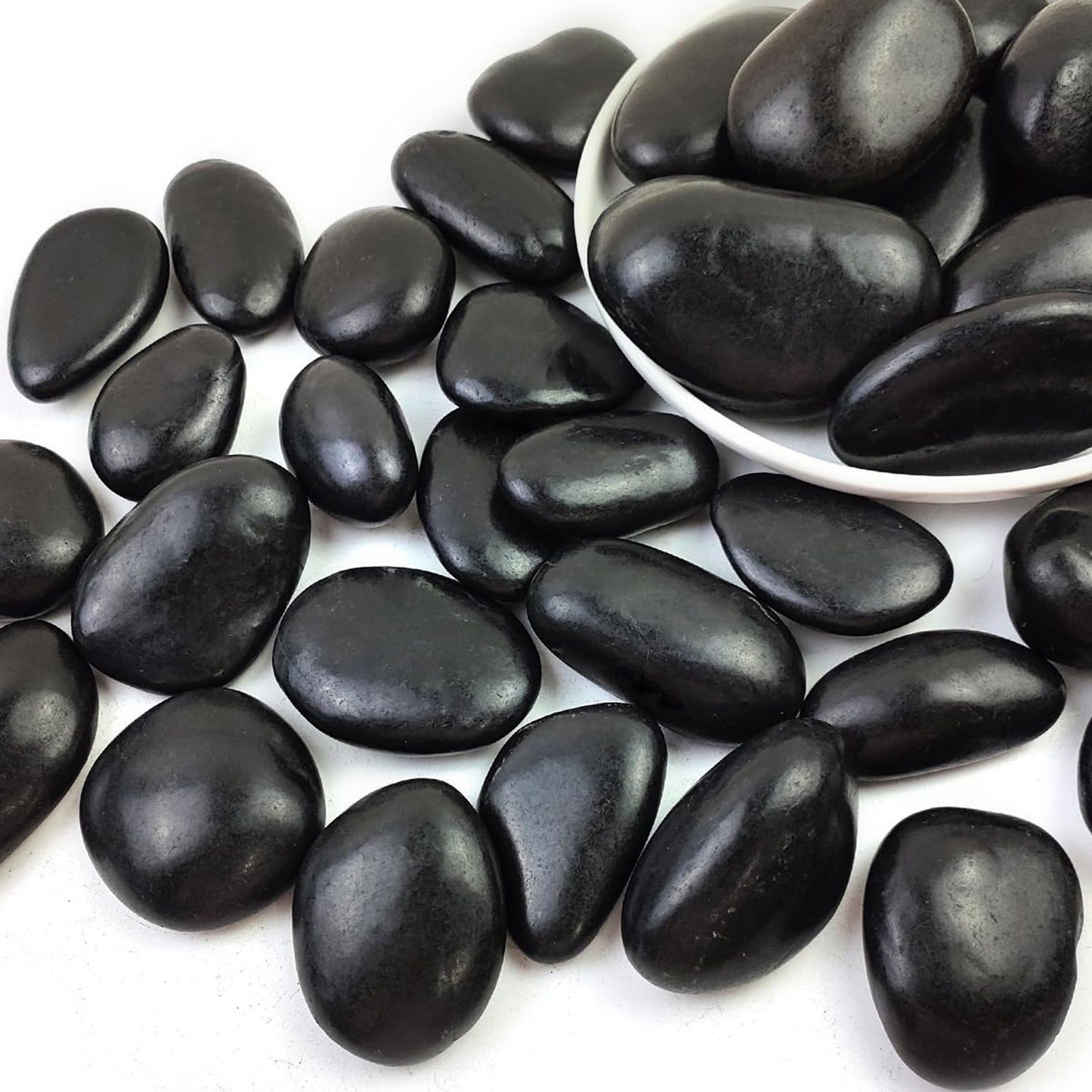 Black pebbles on a white background