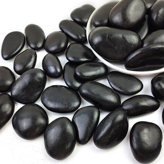 Black pebbles on a white background