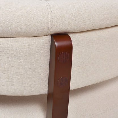 Close-up of a beige sofa with a brown leather armrest