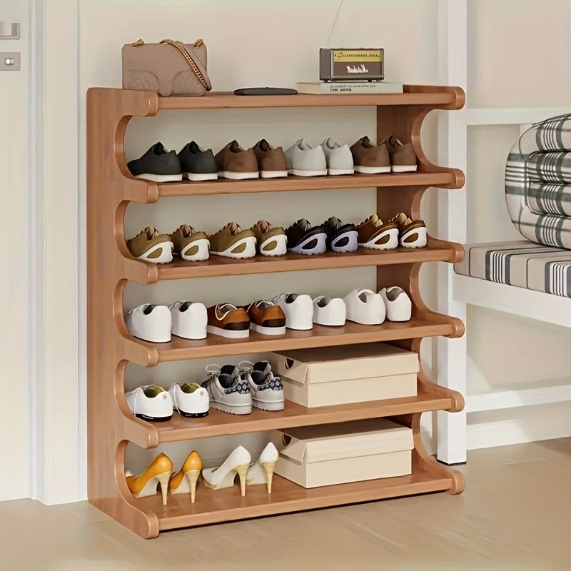Wooden shoe rack with various shoes on shelves in a room setting.