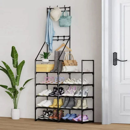 Shoe rack with various shoes, bags, and clothes on a white wall background