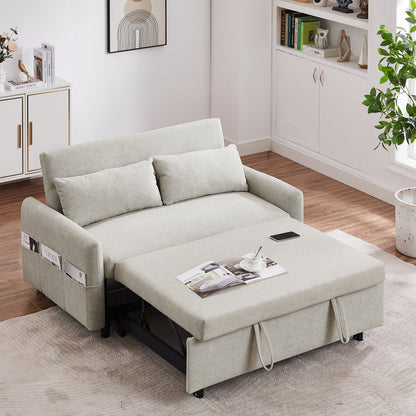 Beige sofa bed in a living room setting with magazines and a phone on it.