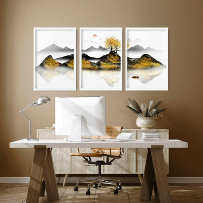 A set of three framed Japanese wall art prints depicting a mountain landscape with a tree and a bird, displayed above a desk in an office setting.